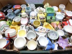 Approximately 50 novelty egg cups including retro, kitsch, Japanese, pottery including Ardmore,