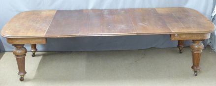 Late 19thC / early 20thC oak wind-out extending dining table with four leaves, moulded edge and