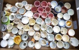 Approximately 60 novelty egg cups including retro, kitsch, Longton Pottery examples, Japanese etc