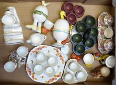 A collection of egg cruets and novelty egg cups including Old Foley, Chintz, Bakelite,