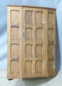 A 19th/20thC Arts and Crafts panelled oak hanging corner cupboard with peg joints, W 64 x H 89cm