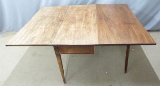 A 19thC mahogany drop leaf three plank table raised on tapering legs, W122 x D155 x H72cm