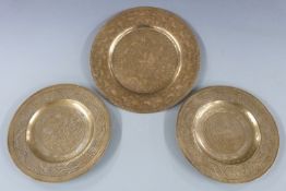 A 20thC brass zodiac charger with engraved decoration and pierced rim (diameter 30cm) and a pair