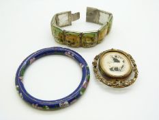 A white metal bracelet set with painted mother of pearl panels, a cloisonne bangle and a Victorian