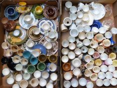 Approximately 130 novelty egg cups including twin branch, saucers, glass, Torquay ware etc