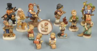 Twelve Goebel Hummel figures including chimney sweep