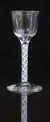 An 18thC drinking glass with white double twist stem and ogee shaped bowl raised on conical foot,