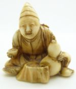 Japanese Meiji period signed ivory netsuke of a seated man with double gourd water bottle, H5.5cm