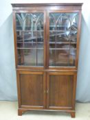 A 19thC glazed cabinet with adjustable shelves and cupboards under raised on bracket feet, W100 x