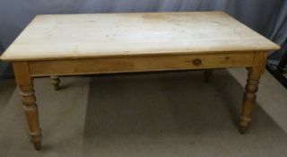 A 19th/20thC scrubbed pine farmhouse table with single drawer, raised on turned legs, W183 x D106