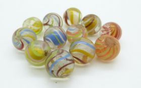 Twelve various glass marbles all with multicolored twist decoration, largest 21mm in diameter
