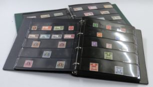 A good collection in two stockbooks of mint commemorative sets, mainly comprising complete George VI