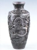 A Chinese carved cinnabar lacquer vase with dragon decoration, 21.5cm tall