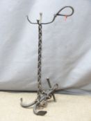 A wrought iron welded companion stand in the form of a fouled anchor, H68cm