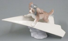 Lladro Collector's Club figure of a puppy wing walking on a paper aeroplane, H11 x L19cm