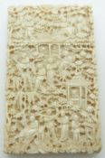 A 19thC Chinese carved ivory card case decorated with court / village scenes, 9.5 x 6cm