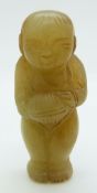 A 19thC Chinese jade toggle depicting a boy holding an object, H5.5cm