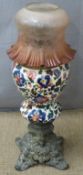 An earthenware oil lamp with frilled glass shade, H 62cm