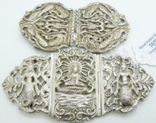 Two white metal buckles in the form of deities