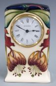 Moorcroft clock decorated in the Anna Lily pattern, H16cm, with box