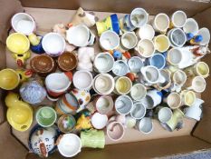 Approximately 50 novelty egg cups including retro, kitsch, Wade, Goebel, Danish pottery, Japanese