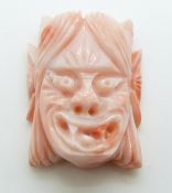 Chinese carved coral mask of a female demon, 3cm.