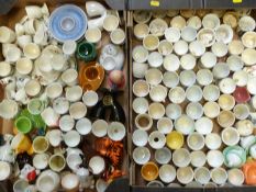 Approximately 130 novelty egg cups including kitsch, retro, some named, pottery nursery ware etc