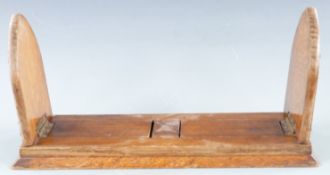 An oak and brass book slide, maximum length 52cm