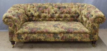Chesterfield sofa raised on turned legs and brass castors, W195 x D90cm