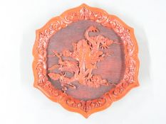 A 19thC/20thC cinnabar lacquer charger decorated with a figure riding a dragon with Guang mark to