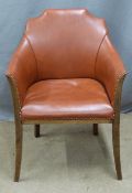 A mahogany framed faux leather armchair
