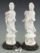 Two Chinese blanc de chine figures on carved hardwood bases, H43cm