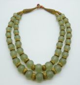 An 18th/19thC Chinese jade beaded necklace interspersed with gilt threaded beads and fastening,