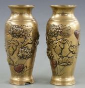 A pair of Japanese brass vases with relief decoration of birds amongst foliage, 15cm tall