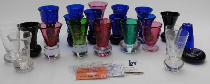 Twenty-two mainly Masonic interest firing glasses including Bristol Blue and cranberry, most with