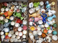 Approximately 100 mostly ceramic egg cups including VW Camper, animals, Devon pottery, Honiton, Toby