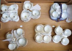 Six ceramic egg cruets, all with four egg cups, tallest 12cm