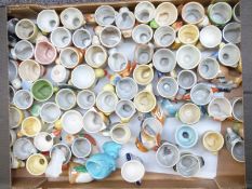 Approximately 55 novelty eggs cups, mainly Japanese, kitsch, retro USSR etc