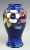 Moorcroft pedestal vase decorated in the Pansy pattern on a blue ground, signature and impressed '