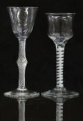 Two 18thC drinking glasses, one with air twist stem and round funnel shaped bowl raised on a conical
