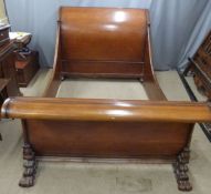A 19th/20thC mahogany sleigh bed raised on ornate carved pad feet, W164 x D137 x H297cm
