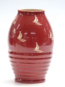 Clarice Cliff vase decorated with boats on a red ground, no 692 to base, H20cm