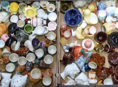 Two trays of novelty egg cups including Spitting Image, pottery etc