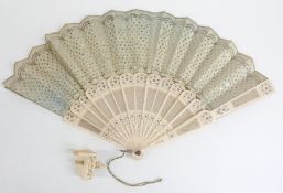 A 19thC pierced and inlaid bone fan and part of a 19thC Chinese carved ivory sewing vice
