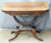 Victorian crossbanded mahogany fold over games table with arched support raised on a quatrefoil base