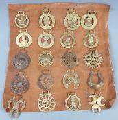 A display of horse brasses on leather, including Victorian and latter commemorative examples