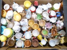 Approximately 40 novelty egg cups including kitsch, Walt Disney figural etc