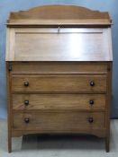 Arts and Crafts oak bureau with fitted eight-drawer interior and three graduated drawers with