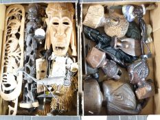 A large collection of African and similar carvings including masks, busts, animals etc