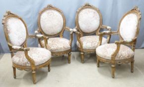 A set of four upholstered French carved oak armchairs